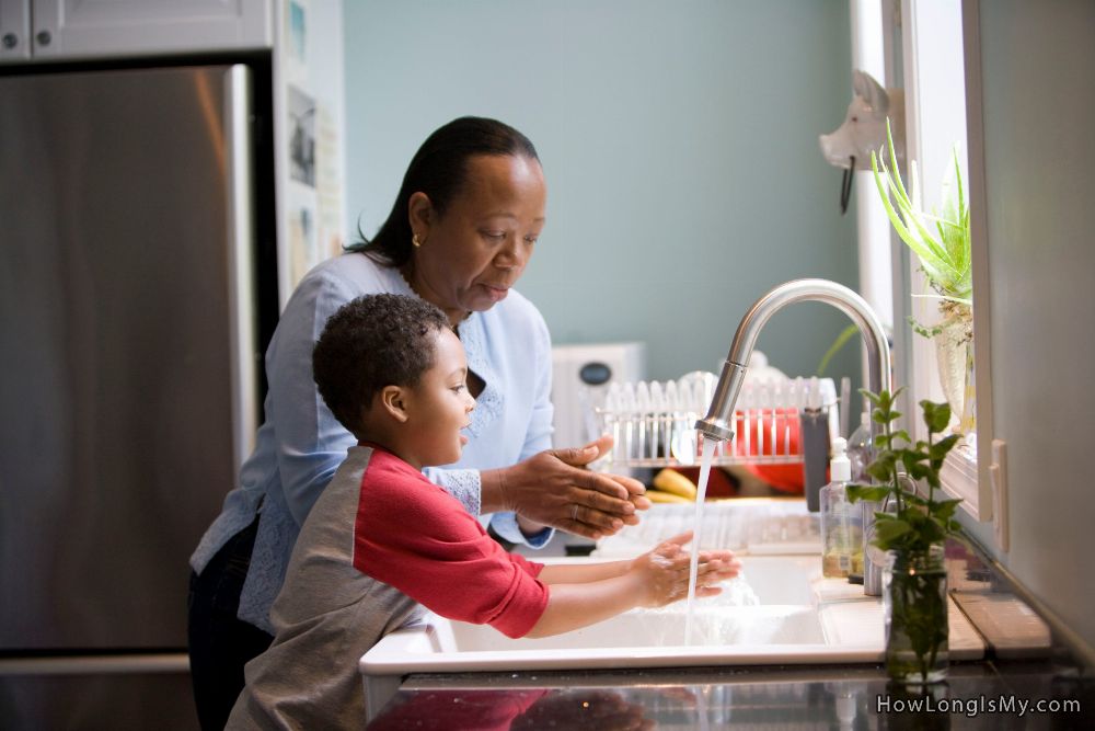 woman and a boy washing hands