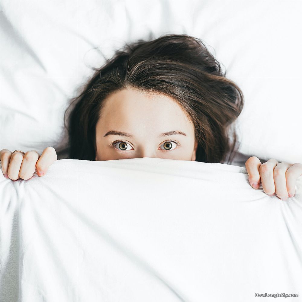 woman hiding behind the sheets bed bugs